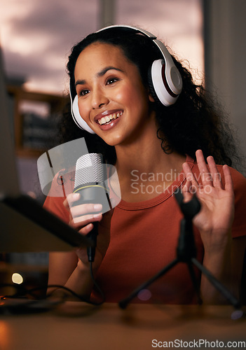 Image of Woman, headphones and mic, radio DJ or podcast with press journalist and live internet broadcast at night. Happy, tech and multimedia, communication and social media streamer with content creation