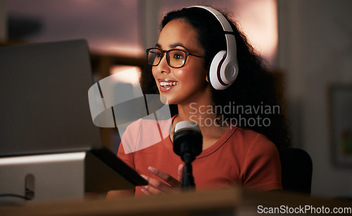 Image of Woman, headphones and laptop with radio DJ or podcast, public relations journalist and live broadcast at night. Mic, talk show and communication for social media streamer and content creation