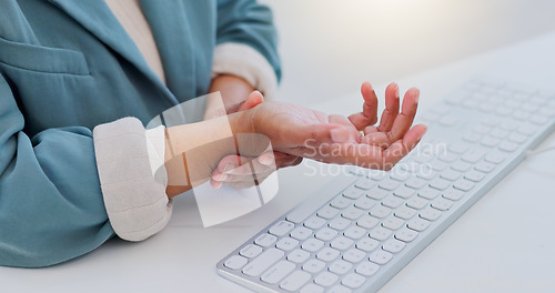 Image of Business woman, hands and wrist pain from carpal tunnel syndrome, typing or injury on office desk. Closeup of female person with sore arm, inflammation or discomfort and joint ache at the workplace