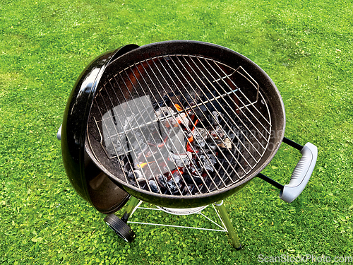 Image of open charcoal grill