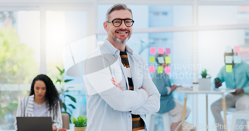 Image of Happy, business pride and a man with arms crossed at a creative agency for consulting and design. Smile, confident and face portrait of a mature leadership management with technology for creative con