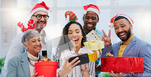 Image of Creative group, Christmas and selfie for party celebration, festive season or December holiday at office. Happy people or employees smile at work event for gifts, surprise or photo in memory and vlog