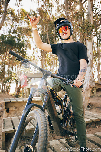 Image of Bike, adventure and hand gesture with a sports man outdoor in a park for off ride riding during a race. Fitness, exercise and bicycle with a young athlete training for a competition in the forest