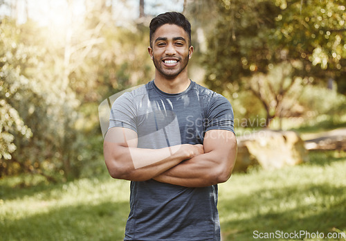 Image of Happy, fitness and portrait of man with arms crossed in a park for workout, running or wellness. Exercise, face and Indian male runner smile in a forest for training, cardio and positive mindset