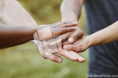 Image of Hands together, closeup and support with team of people outdoor, help and mission with strategy. Huddle, collaboration or partnership with solidarity, trust in community with goals and friends