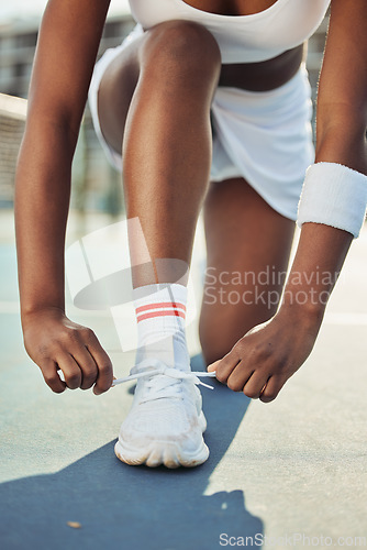 Image of Woman, shoes and tying laces on tennis court getting ready for sports match, game or outdoor practice. Closeup of female person tie shoe in preparation for fitness, exercise or training workout