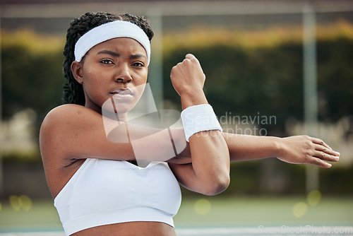 Image of Sports, portrait and woman tennis player doing warm up for practice to play match at stadium. Fitness, serious and African female athlete with stretching exercise for training on court for tournament