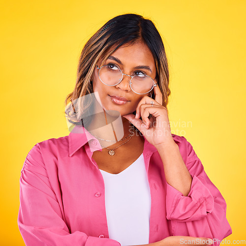 Image of Woman, thinking and vision on yellow studio background for decision making, solution and inspiration for future choice. Indian, mindset for planning and thoughtful girl with idea, face and reasoning