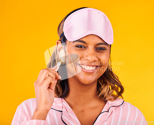 Image of Face roller, morning and portrait of woman with skincare beauty for skin isolated in studio yellow background for dermatology. Facial, detox and young person calm for care and relax with cosmetic