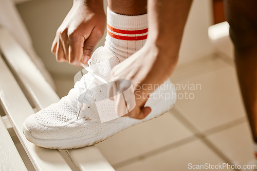 Image of Locker room, sports and person tie shoes for training, exercise and workout for practice or match. Fitness, gym and closeup of athlete tying laces for performance, wellness and ready for competition