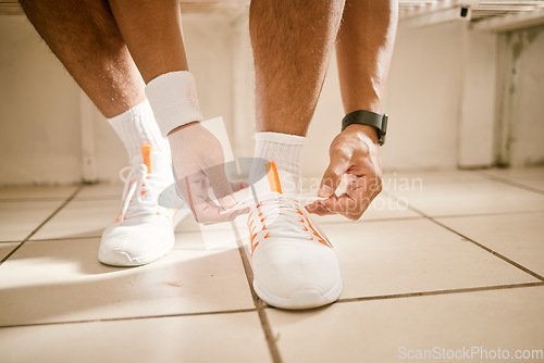 Image of Locker room, fitness and person tie shoes for training, exercise and workout for practice or match. Sports, gym and closeup of athlete tying laces for performance, wellness and ready for competition