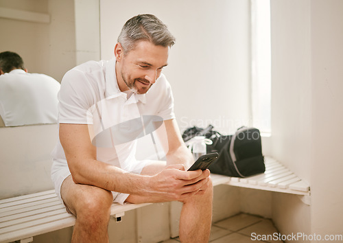 Image of Tennis, phone and man typing on social media after exercise, workout or training in a sports club change room. Smile, connection and athlete chatting on mobile app for communication online or web