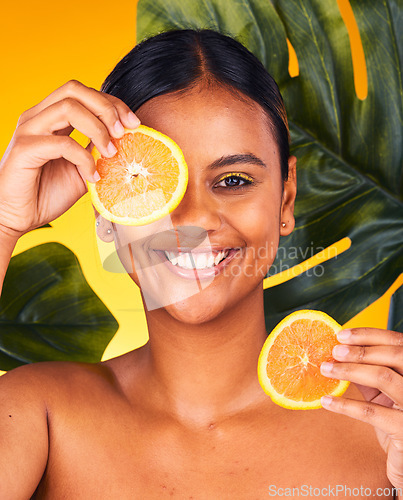 Image of Woman, orange and beauty with natural skincare, dermatology and cosmetics portrait on yellow background. Monstera, citrus fruit and vegan treatment, green facial for vitamin c and skin glow in studio
