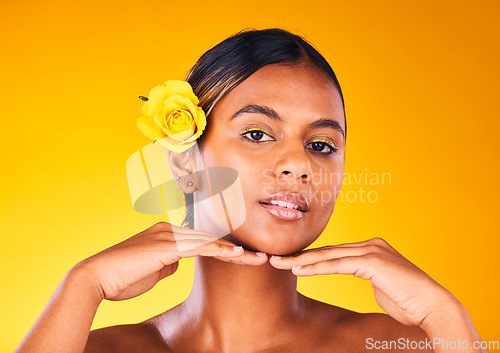 Image of Woman, rose and natural beauty for skincare, dermatology and cosmetics portrait on yellow background. Spring, eco friendly treatment for self care, facial for antiaging with flower and glow in studio