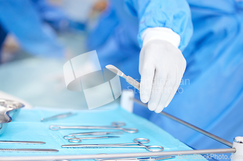 Image of Hand, surgeon and metal tools for surgery in hospital, medical treatment and healthcare with help. Doctor person with equipment for procedure, scalpel and scissors, health and closeup for operation