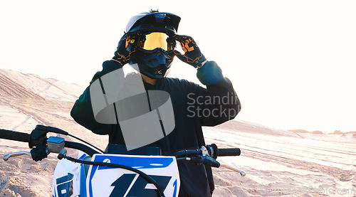 Image of Helmet, motorcycle and an off road biker outdoor for a race, competition or adrenaline in summer. Freedom, energy and flare with a sports rider on a course for power or speed in a reflective visor