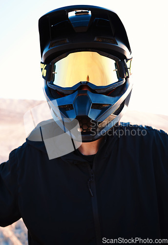 Image of Helmet, freedom and an off road biker outdoor for a race, competition or adrenaline in summer. Flare, energy and adventure with a sports rider on a course for power or speed in a reflective visor