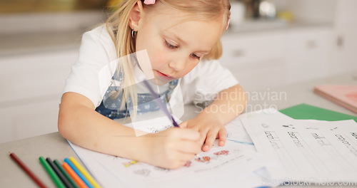 Image of Education, homeschool and child writing, color and learning for development, growth and kindergarten homework. Home study, drawing and happy girl with school project in notebook on kitchen counter.