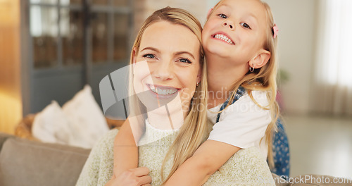 Image of Portrait, hug and mother with girl child on a sofa with care, happy and bond in family home. Smile, face and mom with cute kid in a living room relax with love, trust and support or piggyback games