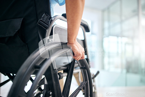 Image of Hand, rehabilitation and person in a wheelchair at a hospital for medical support, transportation and mobility. Closeup, help and a patient with a disability in a chair at a clinic for recovery