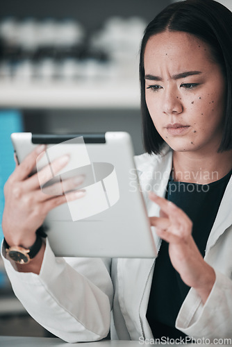 Image of Tablet, pharmacy and confused Asian woman in laboratory for website, wellness app or telehealth. Healthcare, pharmaceutical and person on digital tech online for medical service, medicine or research