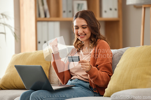 Image of Excited, woman and laptop with credit card, banking and online shopping with fintech, transaction and happiness in a lounge. Person, home and girl on a couch, pc and celebration with payment or bonus