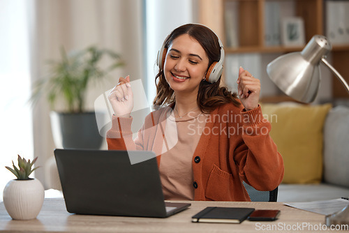 Image of Woman, laptop and headphones for music, home and dancing at desk with inspiration for remote work. Freelance entrepreneur, audio streaming app and listening to radio with smile, computer and sound