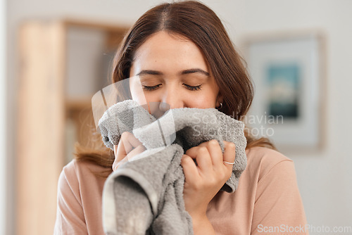 Image of Clean, laundry and woman smell in home and washing, towel or clothes in apartment with housekeeper or maid. Fresh, scent and person spring cleaning fabric, material or cloth with detergent fragrance