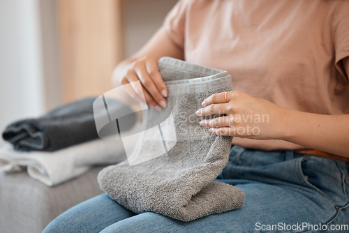 Image of Hands, laundry and towel for woman, home or spring cleaning on living room sofa for hygiene. Cleaner, maid and cotton fabric for hospitality, linen and housekeeping service on lounge couch for chores