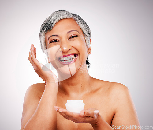 Image of Beauty, portrait and mature happy woman with cream container, skin hydration product or anti aging lotion. Spa dermatology, melasma skincare cosmetics and studio model face on gray background