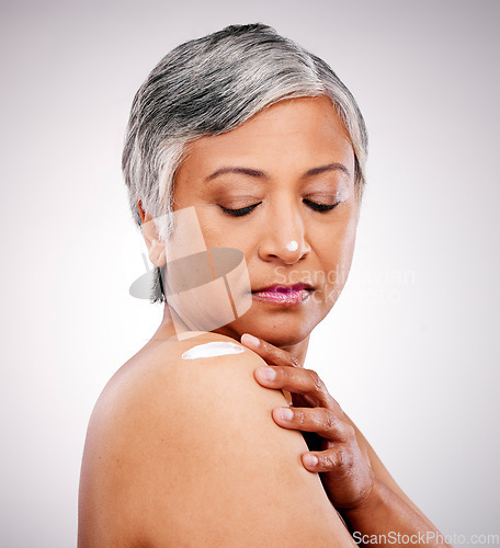 Image of Skin cream, shoulder and beauty of a mature woman with natural glow on a white background. Dermatology, moisturizer and cosmetics of aesthetic model for body shine, wellness or self care in studio