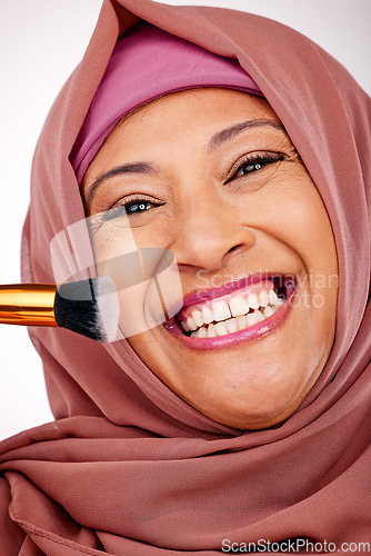 Image of Cosmetic brush, portrait and muslim woman in studio for makeup, natural and face routine. Smile, self care and happy mature islamic female model with cosmetology tool for facial glamour treatment.