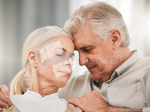 Image of Old couple, hug and forehead touch, relax on sofa with love and support, bonding while at home with trust and comfort. People together in marriage, partner and retirement with calm and peace of mind