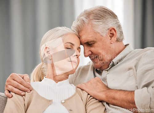 Image of Old people, hug and forehead touch, relax on sofa with love and support, bonding while at home with trust and comfort. Couple together in marriage, partner and retirement with calm and peace of mind