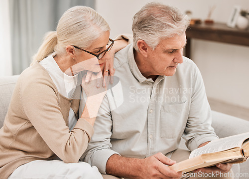 Image of Bible study, faith and senior couple with a book in a living room relax, reading and bond at home. God, Worship and retired elderly people with scripture, guidance or gospel, love and Jesus praise