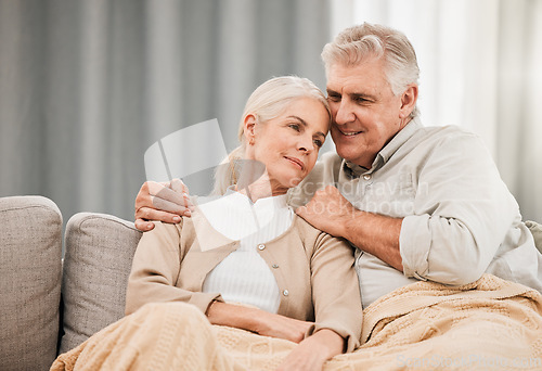 Image of Old couple, hug and relax on couch with love and support, bonding while at home with trust and comfort. People with time together, marriage or life partner with retirement, calm and peace of mind