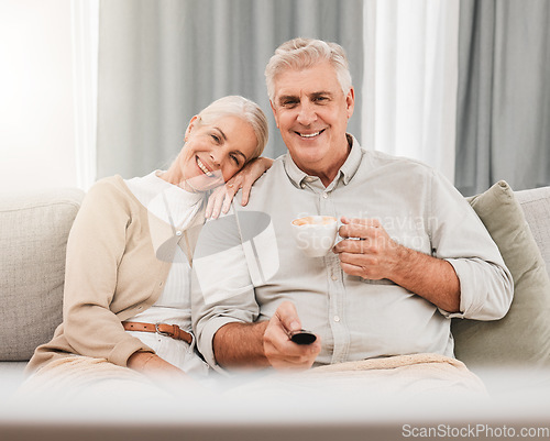 Image of Old couple, happy on couch with coffee and watching tv, time together in retirement, bonding and love at home. People relax with online streaming, subscription and remote control with tea and a show