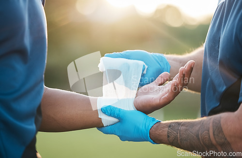 Image of Sports, injury and man with bandage on wrist for accident, emergency and first aid for muscle sprain. Fitness, healthcare and medic with athlete with arm pain from exercise, workout and training