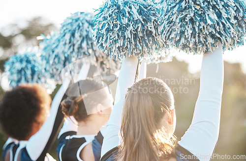 Image of Cheerleader, sports and women with hands raised on field for performance, dance and game motivation. Teamwork, dancer and people in costume cheer for support in match, competition and event outdoors