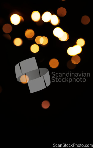 Image of Gold, light and mockup with bokeh on dark background for New Year, Christmas or festive fireworks celebration at night. Mock up, space or sparkle in winter with magic, glow or shine on black backdrop