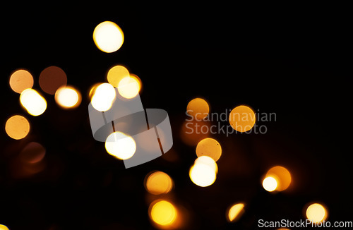 Image of Gold, bokeh and light in a studio with a dark background for celebration, event or party. Mockup, confetti and yellow for glow, magic or shine for festive decoration by a black backdrop with mock up.