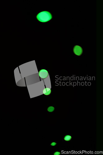 Image of Green light, bokeh and shine on dark background isolated on a mockup space. Blur, black backdrop and defocused glow, sparkle or glitter at night for Christmas, holiday or party with magic color dots