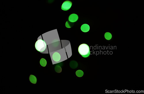 Image of Green light, bokeh and dots on dark background isolated on a mockup space. Blur, black backdrop and defocused shine, sparkle or glitter at night for Christmas, holiday or party with magic of color