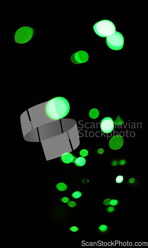 Image of Green, glitter and bokeh in a studio with dark background for celebration, event or party. Confetti, lights and color sparkles for magic, shine or glow for festive by black backdrop with mockup.