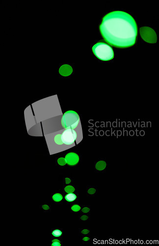 Image of Bokeh, green particles and lights on black background with pattern, texture and mockup with cosmic aesthetic. Night lighting, sparkle dots and glow on dark wallpaper with space, color shine and flare