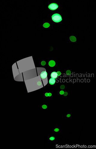 Image of Bokeh, green dots and light on black background with pattern, texture and mockup with cosmic aesthetic. Night lighting, sparkle particles and glow on dark wallpaper with space, color shine and flare.