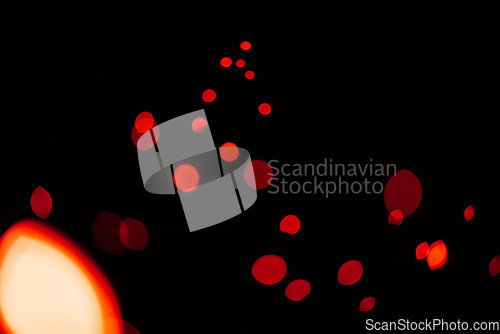 Image of Red, glitter and bokeh in a studio with dark background for celebration, event or party. Confetti, lights and color sparkles for magic, shine or glow for festive by black backdrop with mockup.