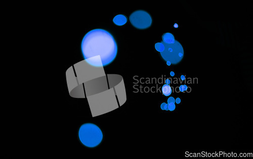 Image of Bokeh, blue particles and lights on dark background with pattern, texture and mockup with cosmic aesthetic. Night lighting, sparkle dots and glow on black wallpaper with space, color shine and flare.