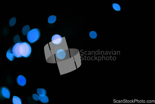 Image of Bokeh, blue dots and mockup on black background with pattern, texture and lights with cosmic aesthetic. Night lighting, sparkle particles and glow on dark wallpaper with space, color shine and flare.