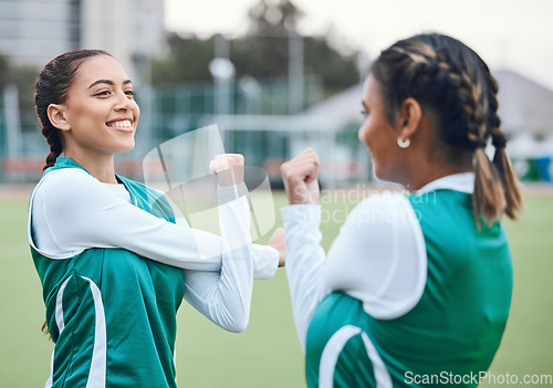 Image of Hockey, fitness and women stretching in team training, practice or sports workout exercise on turf. Teamwork, smile or happy female athlete with flexibility ready to start a game in warm up together